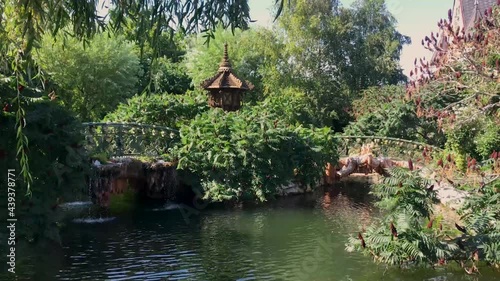  A fragment of the landscape of the park in the Japanese style-with a bridge, fountains and flowering trees. Ravadinovo castle 