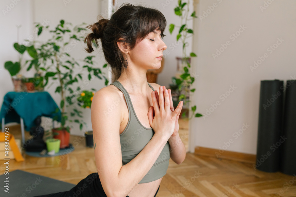Close up image of a young woman practice yoga at home 