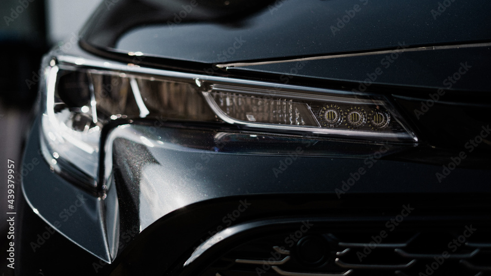 A front view of a black cars headlights