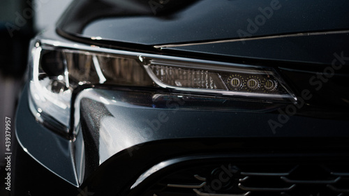 A front view of a black cars headlights photo