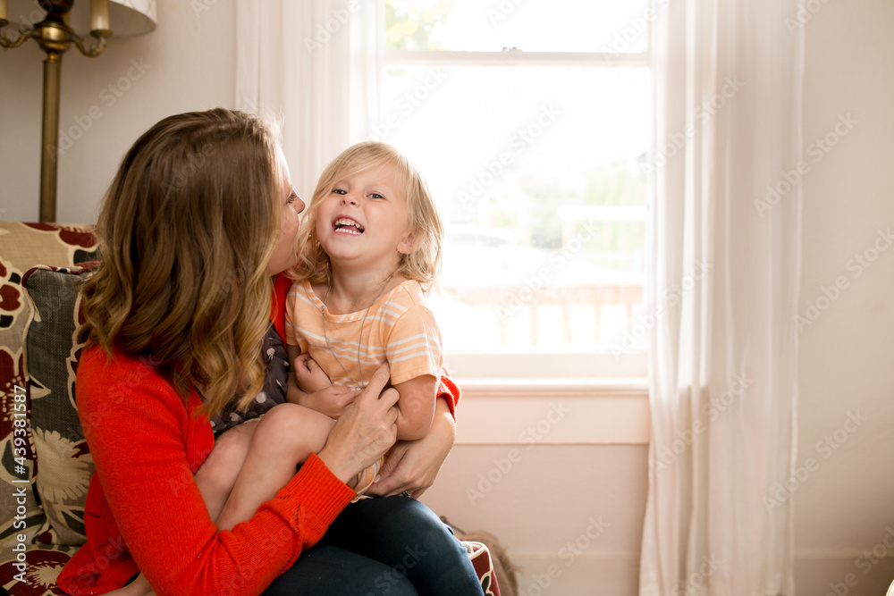 Mother tickles laughing daughter Mother tickles laughing daughter