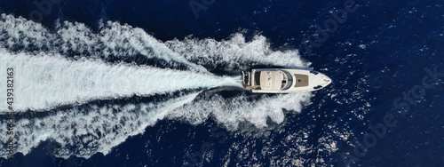 Aerial drone ultra wide panoramic top down photo of small luxury yacht cruising open ocean deep blue sea © aerial-drone