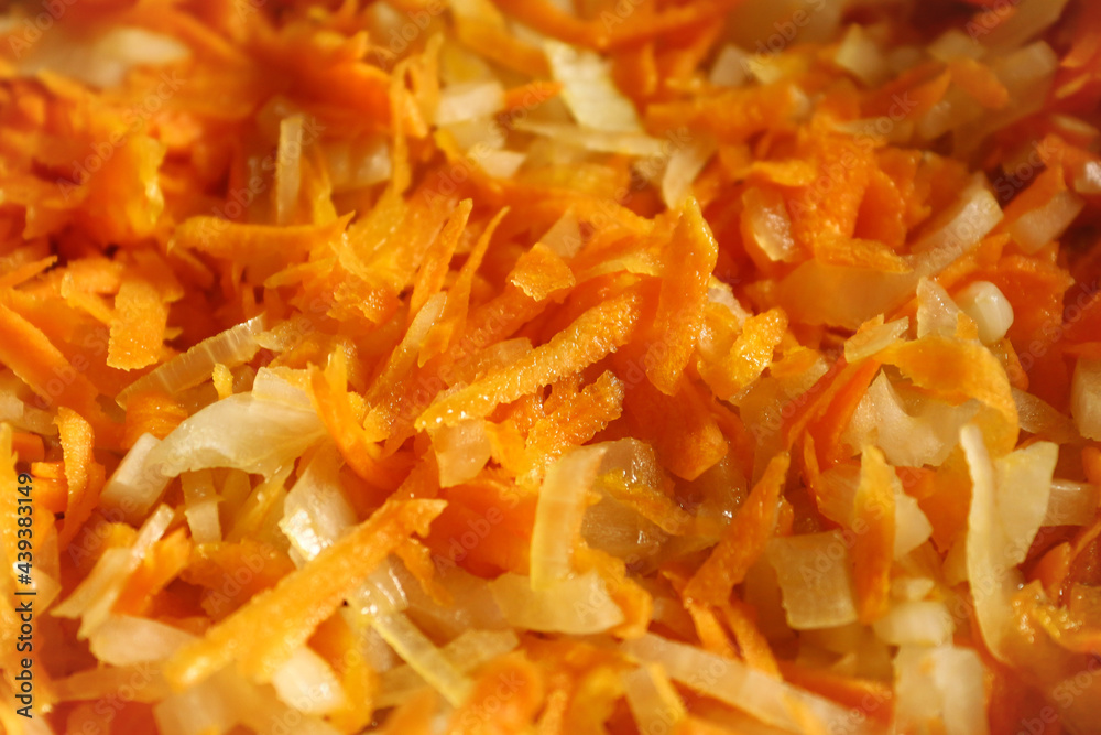 Color photograph of sliced carrots and onions. Healthy vegetables with vitamins. Vegetarianism and veganism. Color photograph of sliced carrots and onions. Healthy vegetables with vitamins. Vegetarianism and veganism.