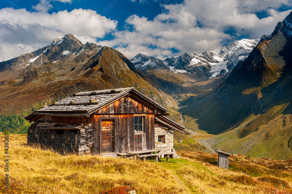 panoramic mountain range with wooden hut