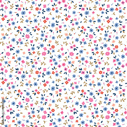 Seamless floral pattern. Ditsy background of small colorful flowers. Small-scale flowers scattered over a white background. Stock vector for printing on surfaces and web design.