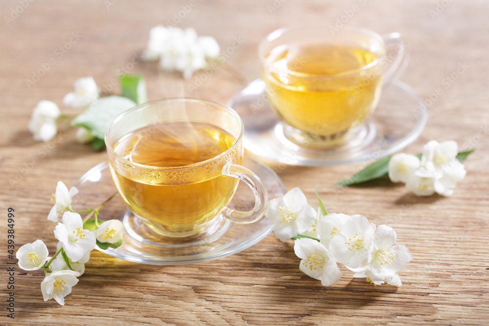 cups of jasmine tea and fresh jasmine flowers cups of jasmine tea and fresh jasmine flowers