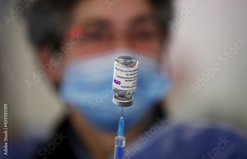 Medical worker holds needle and vaccination against coronavirus, COVID-19 in hospital.