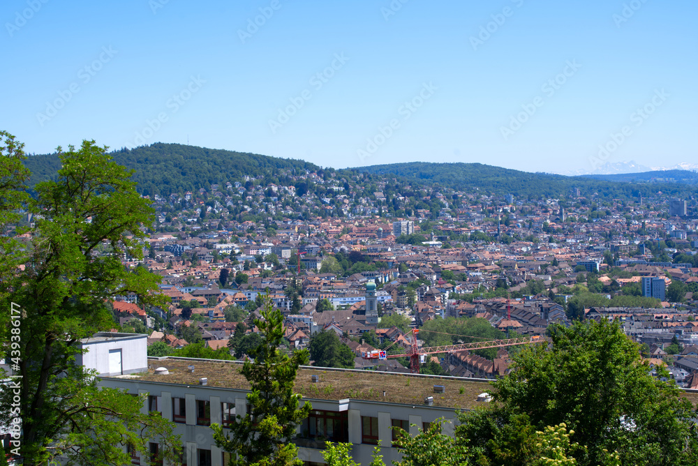 Panorama view over the City of Zurich with mountains in the background at a beautiful summer day. Photo taken June 14th, 2021, Zurich, Switzerland. Panorama view over the City of Zurich with mountains in the background at a beautiful summer day. Photo taken June 14th, 2021, Zurich, Switzerland.