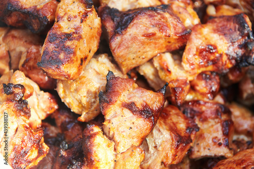 Pieces of delicious barbecued meat. Pork meat cooked on grill. Close up top view.