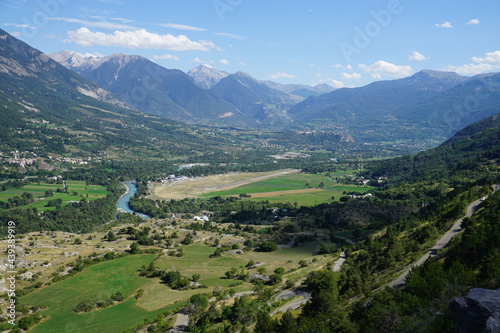 view from the top of the mountain of the valley of Guillestre  France with the river and road