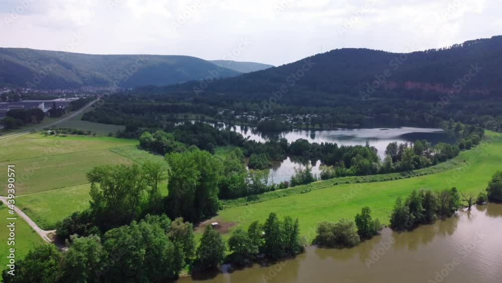 Yellow river and blue lake on the shore of the camp with tourists