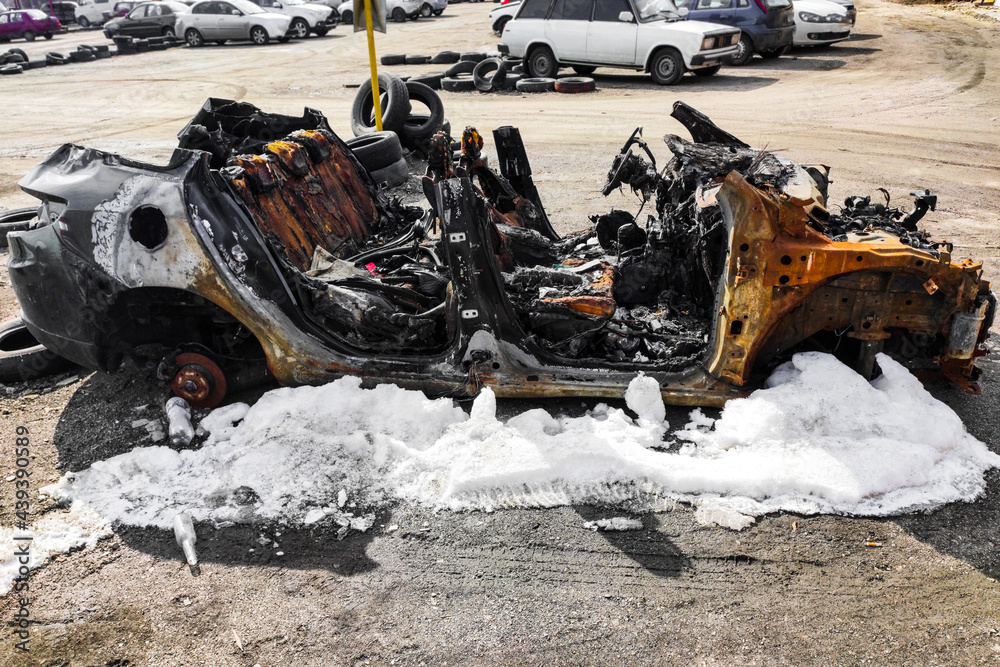 Φωτογραφία Burned-out car after arson accident. Melted plastic in a fire.