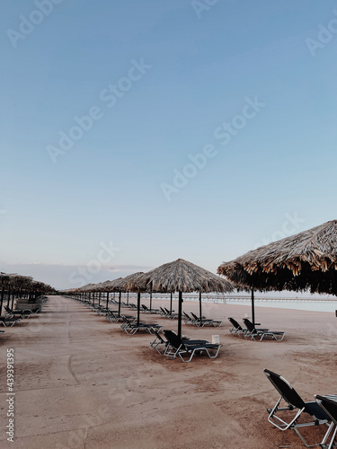 Beautiful lounge pavilion canopy for relax on the beach with sea side view and blue sky. Tent made of dry palm leaves. Luxury summer vacation in tropical paradise resort hotel