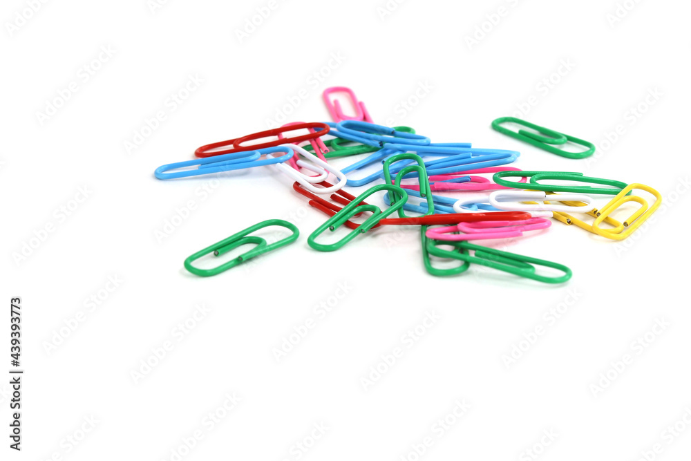 Paper clips of different colors on a white isolated background Paper clips of different colors on a white isolated background
