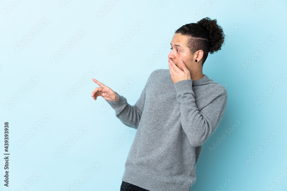Caucasian man over isolated background with surprise expression while pointing side Caucasian man over isolated background with surprise expression while pointing side
