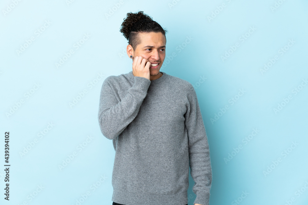Caucasian man over isolated background is a little bit nervous Caucasian man over isolated background is a little bit nervous