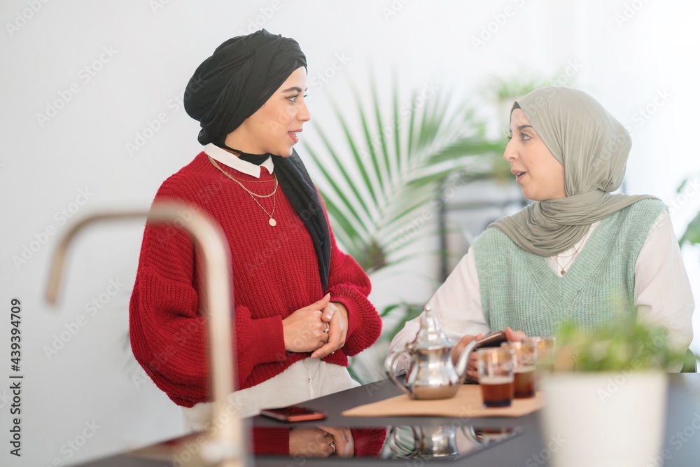 Arab women talking to each other during tea ceremony Arab women talking to each other during tea ceremony