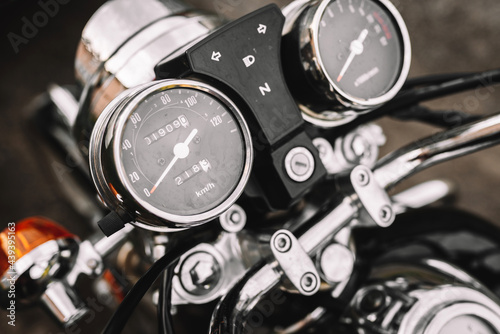 Motorcycle detail with speedometer. Chrome motorcycle details closeup. 