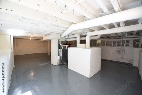 brightly lit clean and white unfinished basement