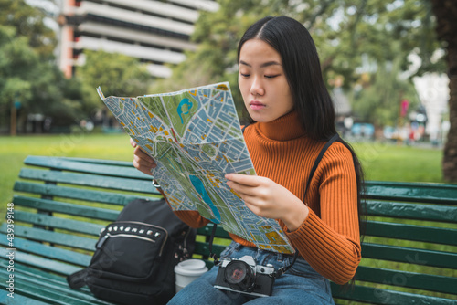 Asian woman looking at a map. photo