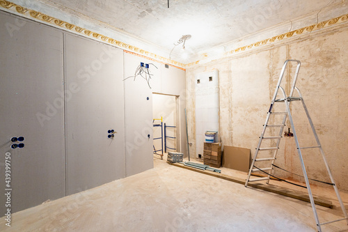 Working process of installing gypsum walls from plasterboard -drywall - in apartment is under construction, remodeling, renovation, extension, restoration and reconstruction.