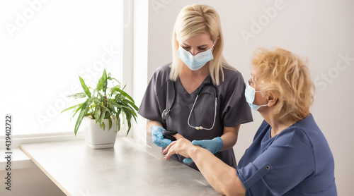 close up doctor  doctor talk with old female patient about disease symptom  doctor use fingertip pulse oximeter with old patient  elderly health check up and health screening  medical technology