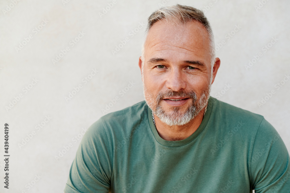 Smiling mature man sitting outside in summer Smiling mature man sitting outside in summer