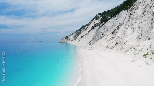 Drone raising shot of beautiful scenic beach with white sand and turquoise blue sea water. Egremni beach of Lefkada island. Egremni one of the most famous beaches in the world for their bluest waters photo