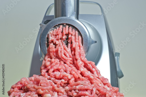 Raw fresh minced meat and electric meat grinder