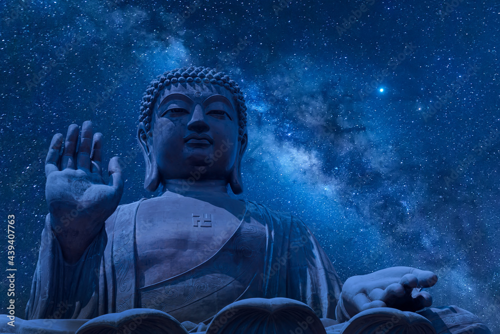 The big Tian Tan Buddha at Po Lin Monastery in Hong Kong during night time. Beautiful night sky with stars and milky way The big Tian Tan Buddha at Po Lin Monastery in Hong Kong during night time. Beautiful night sky with stars and milky way
