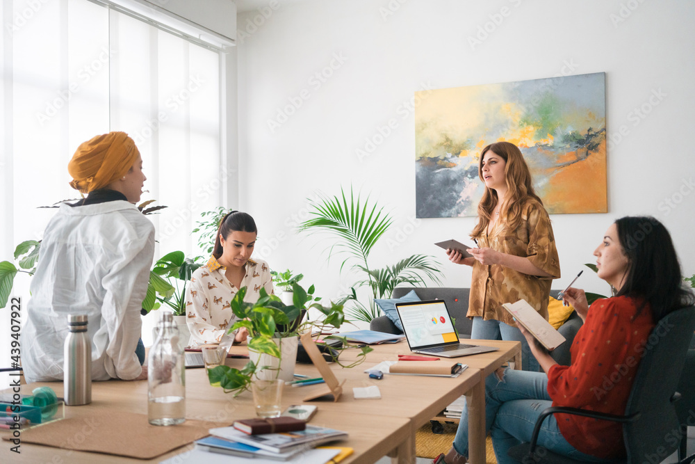 Multiracial young focused businesswomen brainstorming in office Multiracial young focused businesswomen brainstorming in office