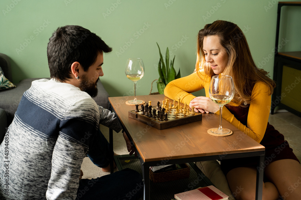 Couple playing chess at home Couple playing chess at home