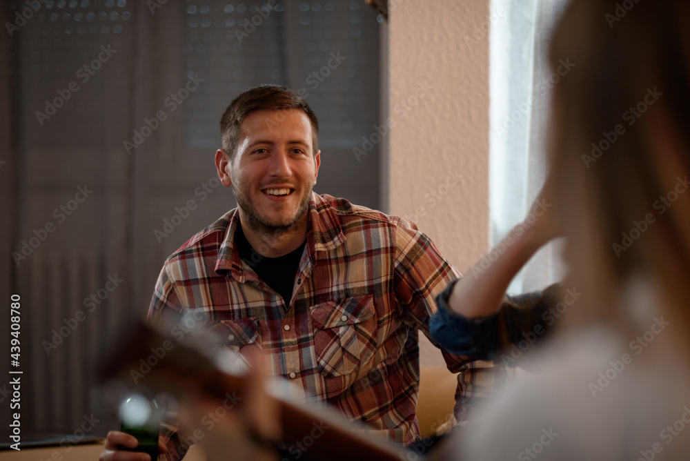 Handsome man on a house party having fun and drinking bee Handsome man on a house party having fun and drinking bee