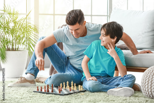 Father and son playing ches...
