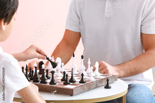 Father and son playing chess, closeup