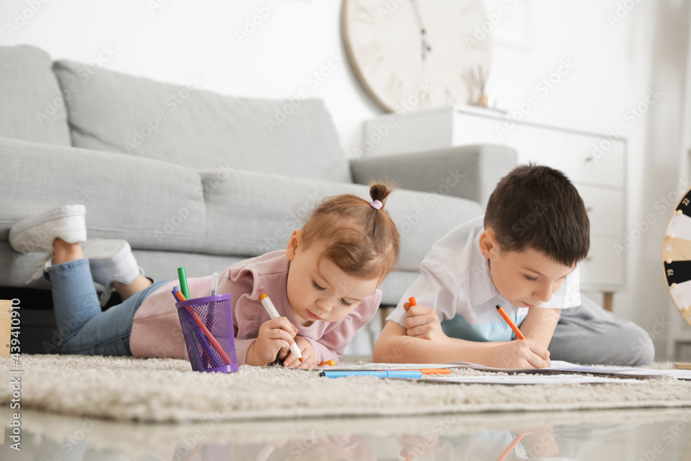 Cute little children drawing at home
