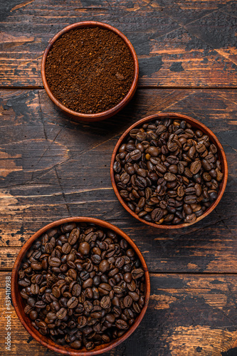 Background of coffee beans and grinded ground coffee. Dark wooden background. Top view © Vladimir