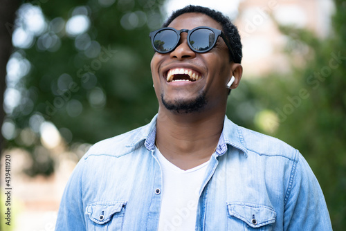 Man smiling while standing outdoors. photo