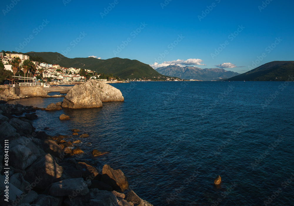 Beautiful view of resort town by the sea, in bay among green mountains and clear blue sky, Montenegro, Herceg Novi