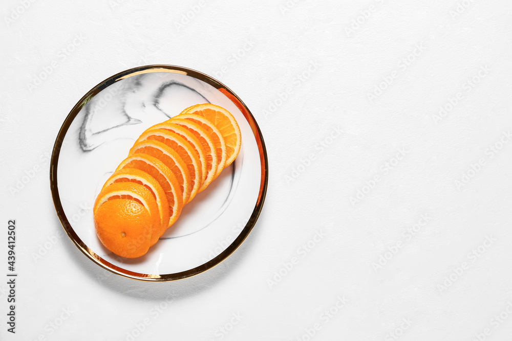 Plate with sliced juicy orange on light background Plate with sliced juicy orange on light background