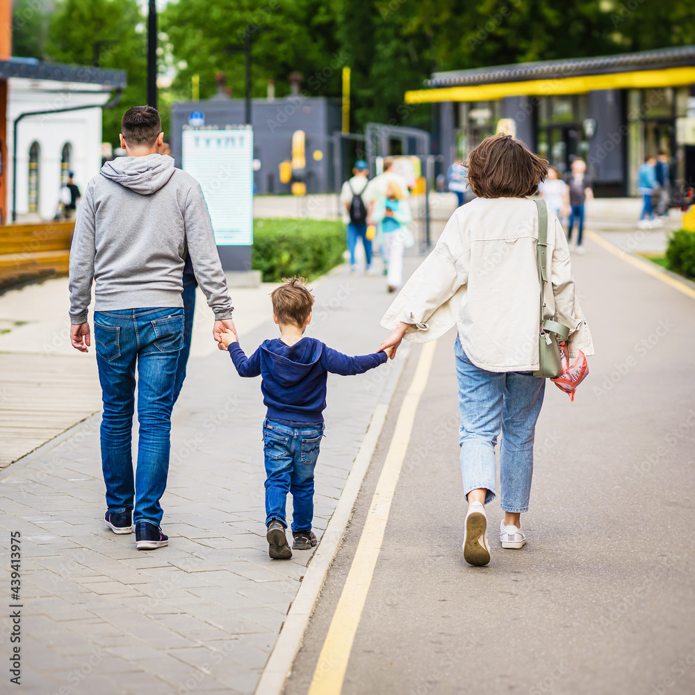 Abstract family walking in the park. Concept of modern City life, lifestyle. Regular people out in public places Abstract family walking in the park. Concept of modern City life, lifestyle. Regular people out in public places