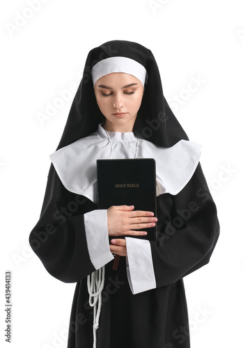 Young praying nun with Bibl...
