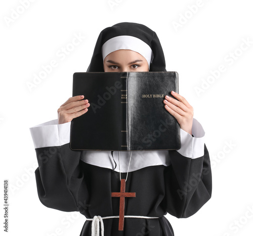 Young nun with Bible on whi...