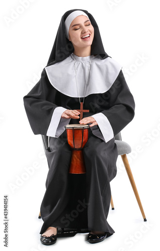 Young nun with drum on whit...