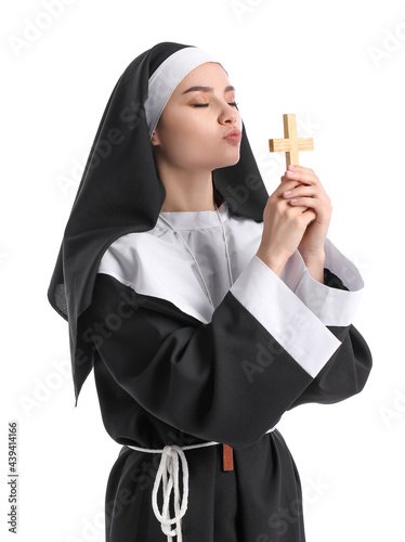 Young nun with cross on whi...