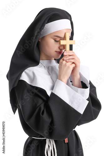 Young praying nun on white ...