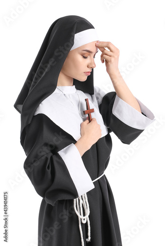 Young praying nun on white ...