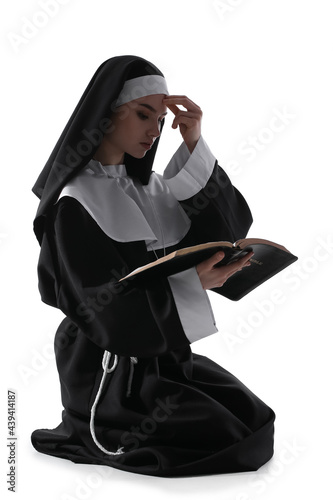Young praying nun with Bibl...
