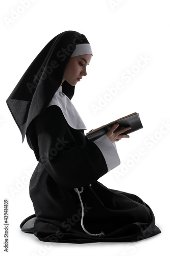 Young praying nun with Bibl...