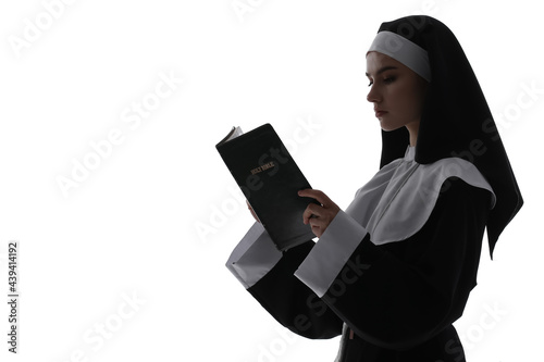 Young praying nun with Bibl...